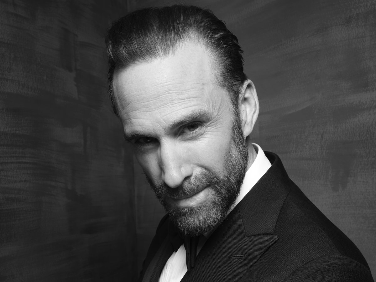 A close-up of a man looking at the camera with his head angled slightly to the side.