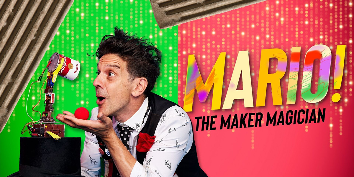 Mario, dressed in a patterned white shirt and black waistcoat, performs a magic trick with colourful props against a neutral backdrop. Text reads 'Mario The Maker Magician'
