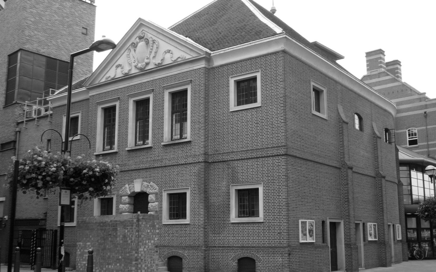 The exterior of the Sam Wanamaker Playhouse, showcasing its ornate architecture and warm wooden tones.